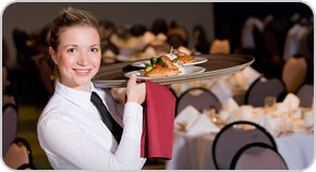 Photo of a restaurant server holding plates of food