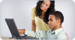 Photo of a husband and wife working at a computer