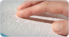 A person reading a Braille document.
